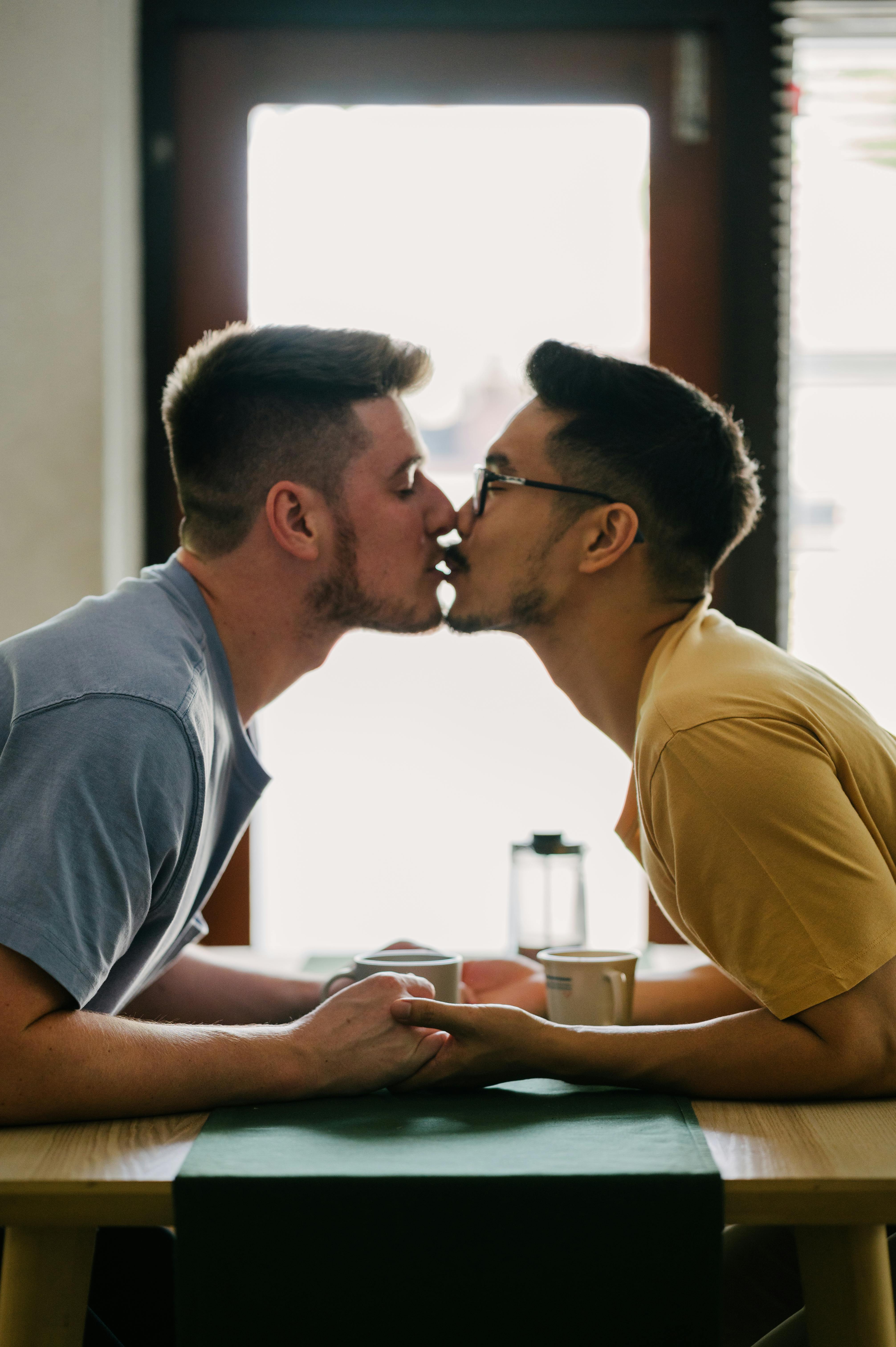 Man Kissing Another Man on the Forehead · Free Stock Photo