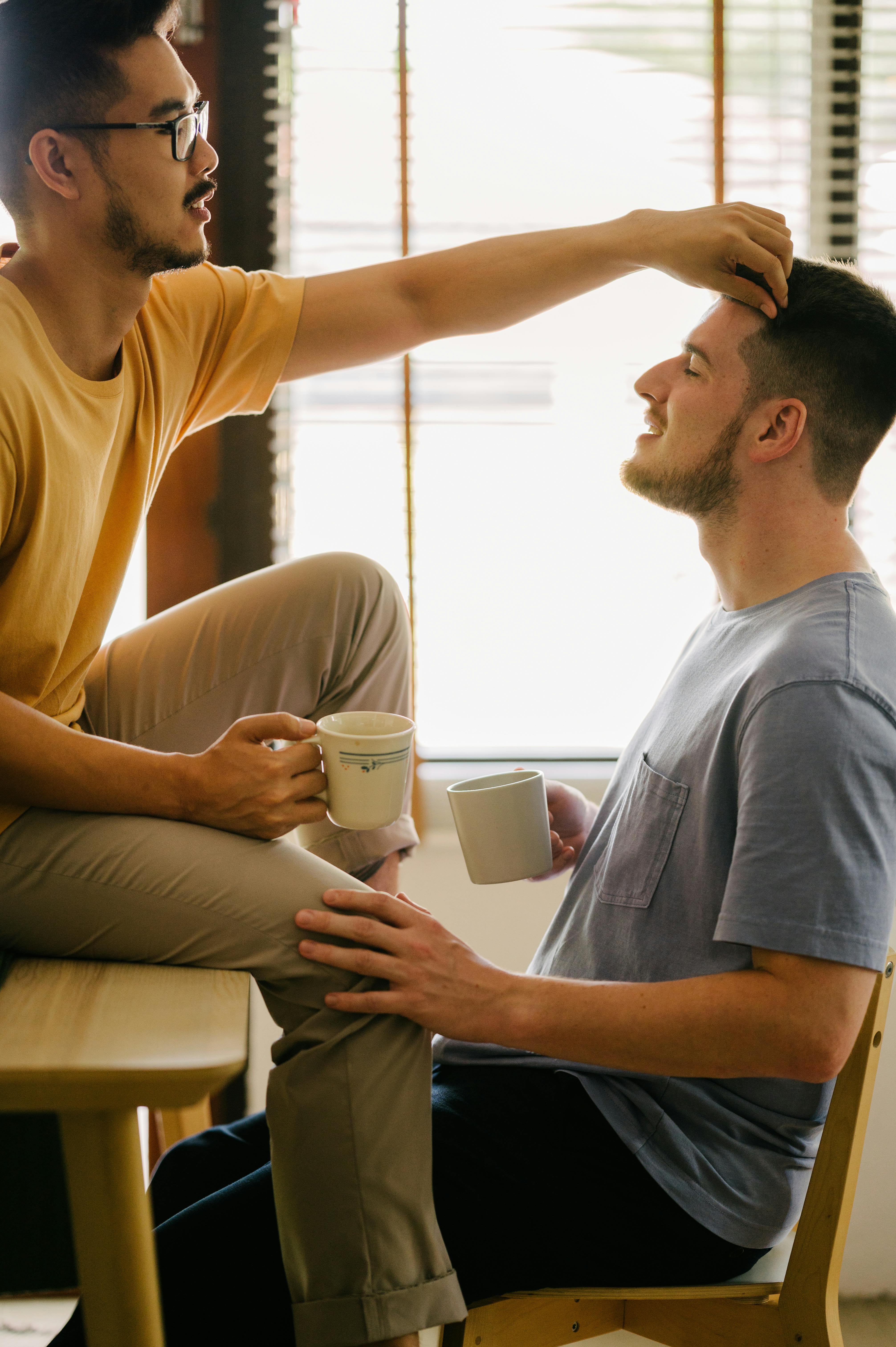 a couple facing each other holding their cups