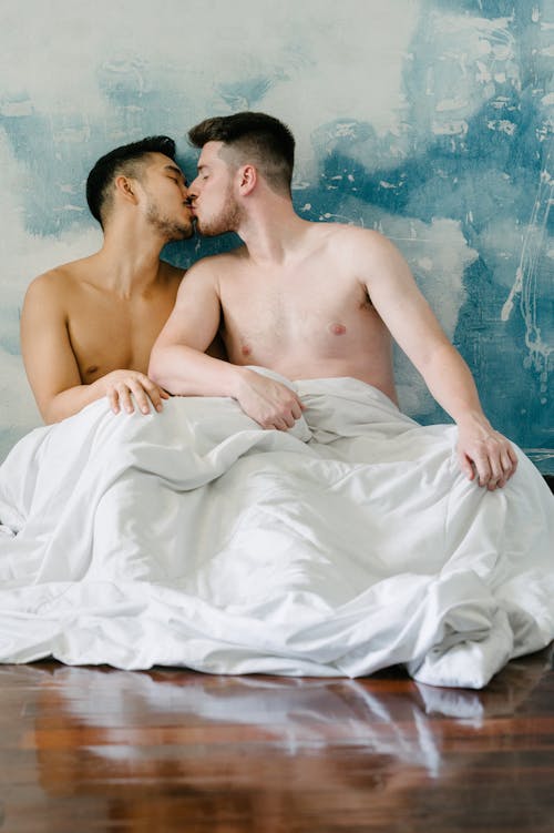 Two Shirtless Men Kissing