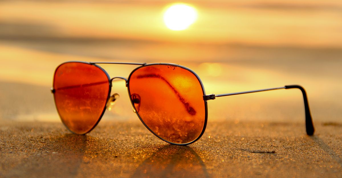 Sunglasses on a table beside a sunny window
