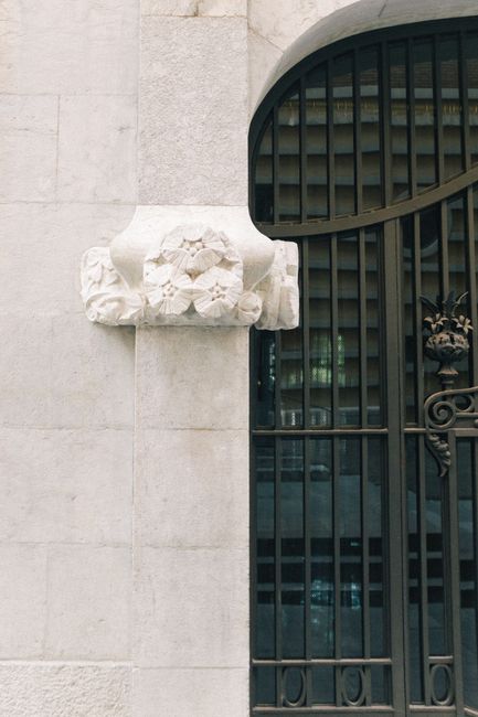Intricate bas relief and metal gate on a Spanish-style building.
