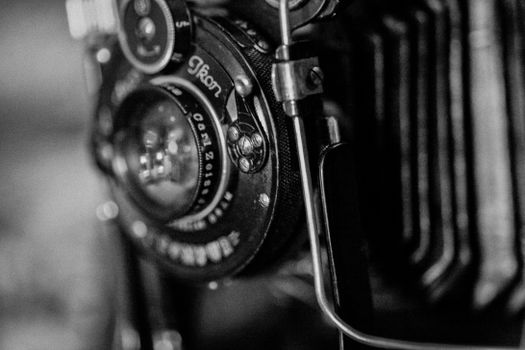 Detailed shot of a classic vintage camera lens in monochrome, highlighting its intricate design.