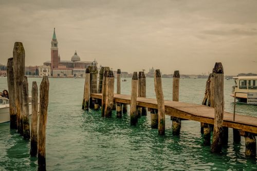Free Explore the serene wooden dock overlooking San Giorgio Maggiore in Venice, Italy. Stock Photo