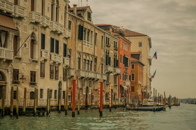 A Row Of Houses Near A Body Of Water