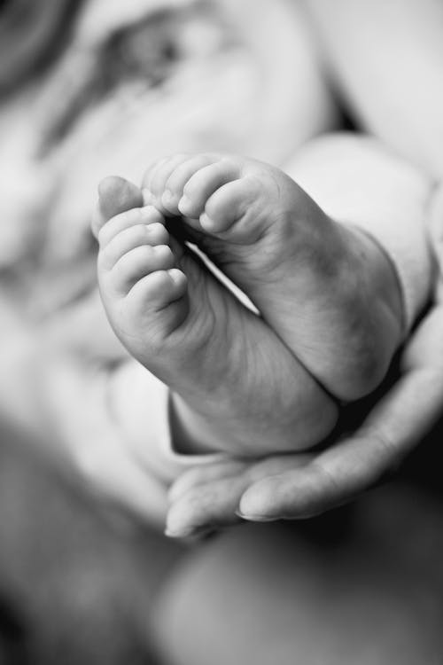 Grayscale Photo of Babys Feet