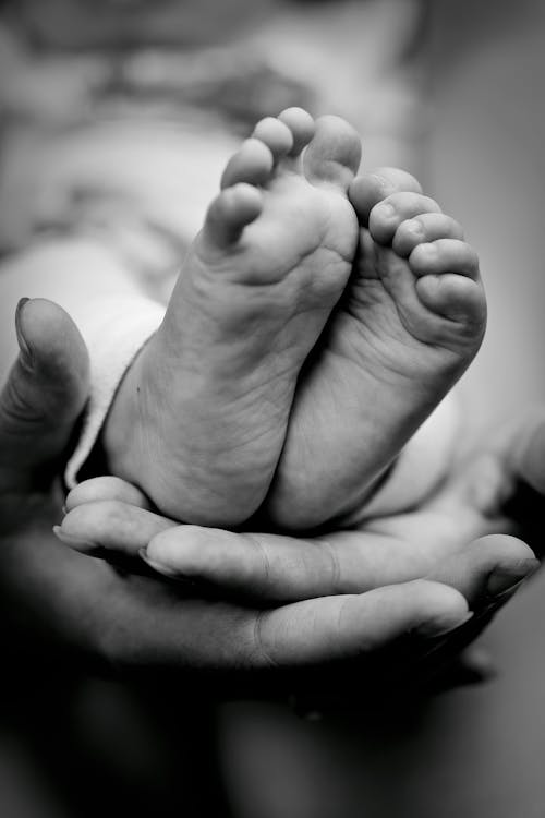 Grayscale Photo of a Newborn Baby Feet