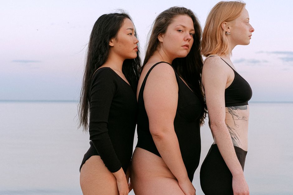 different types of engraving techniques - Three young women stand side by side on the beach, showcasing body diversity.