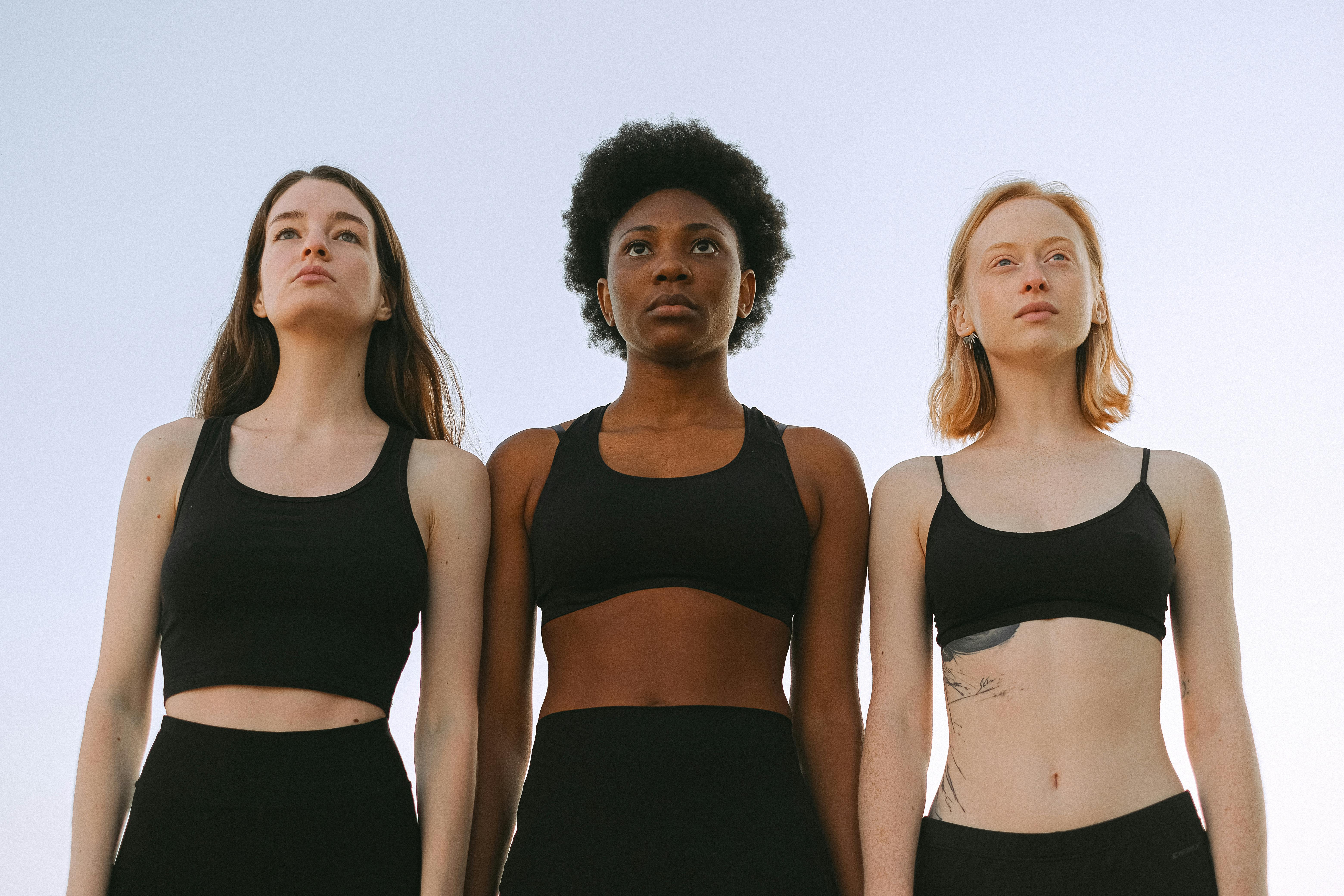 group health insurance Coral Springs companies - Three diverse women confidently standing together, symbolizing empowerment and unity.