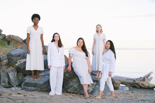 Free Group of Women Standing at the Beachside Stock Photo