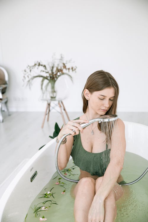 Photo Of Woman Sitting On Bathtub