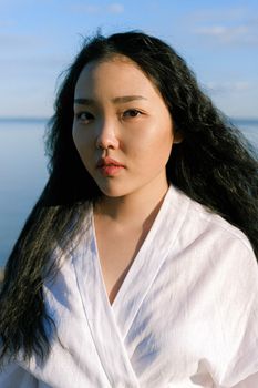 海边，一位优雅的女人散发着自信和迷人的魅力