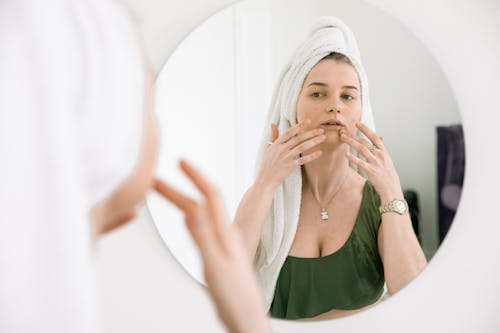 Free Woman in White Head Towel Massaging Her Face Stock Photo