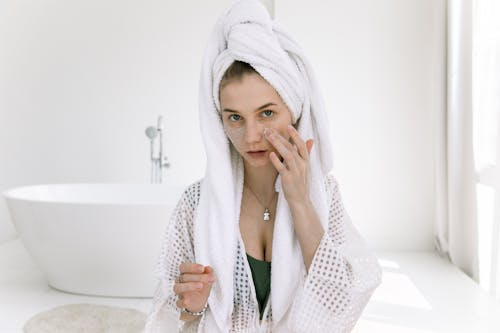 Photo Of Woman Applying Cosmetics On Her Face