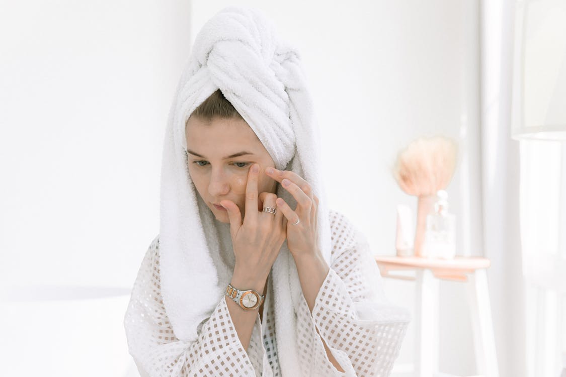 Free Photo Of Woman Applying Eye Mask On Her face Stock Photo