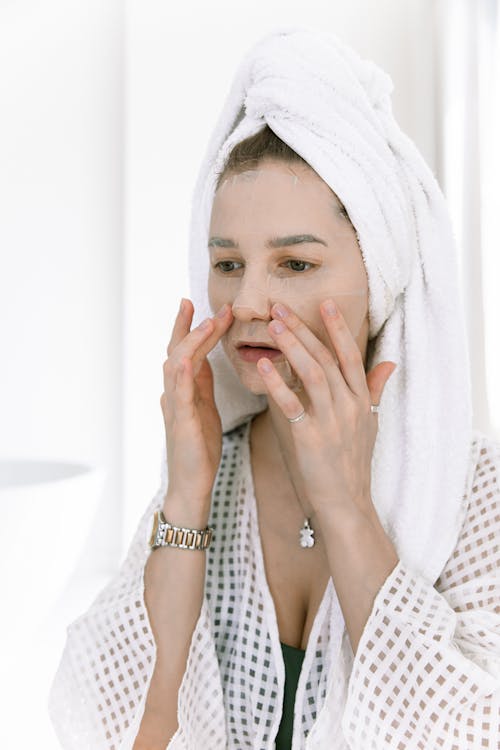 Close-Up Photo Of Woman Touching Her Face