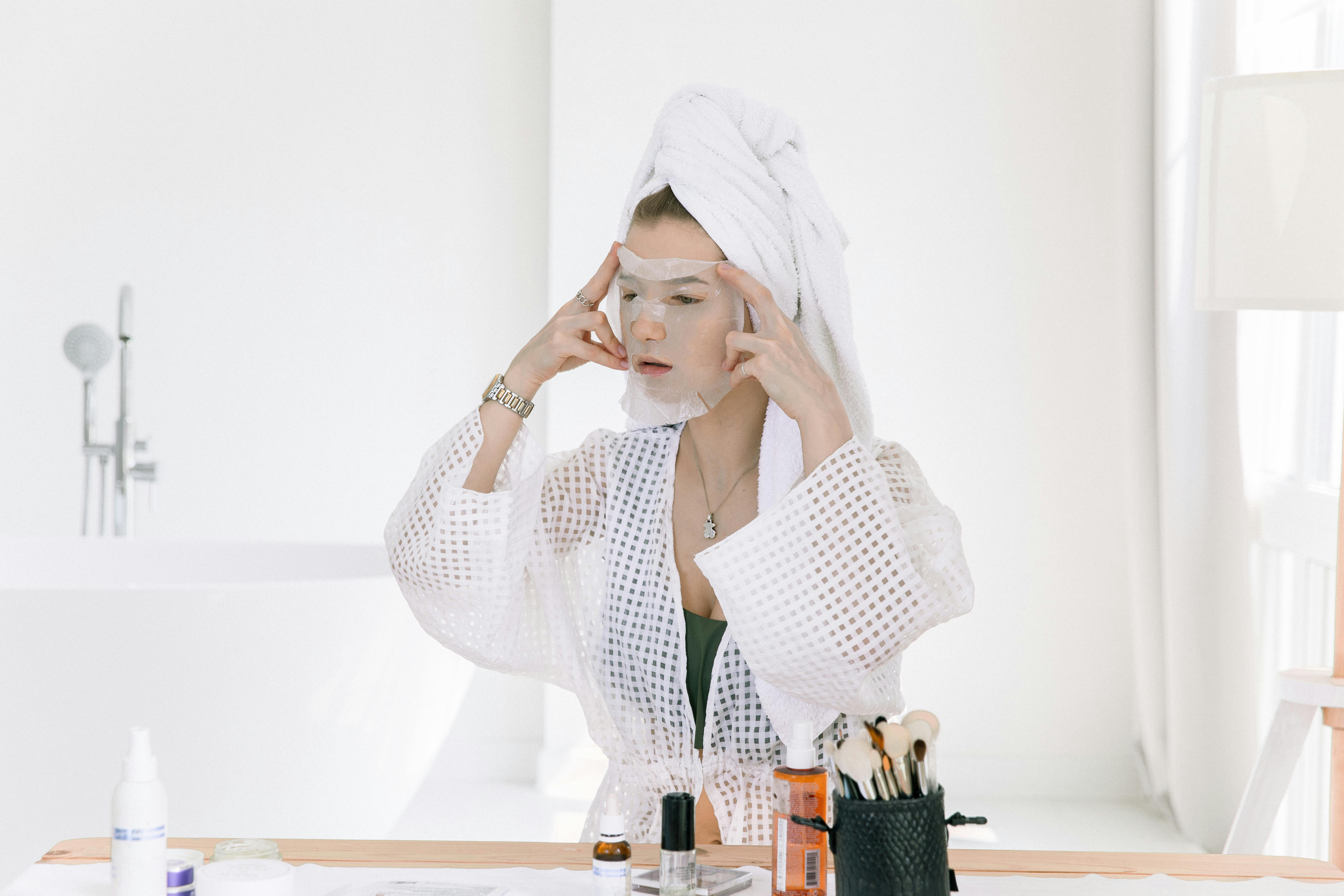 Free Photo Of Woman Applying Face Mask On Her Face Stock Photo