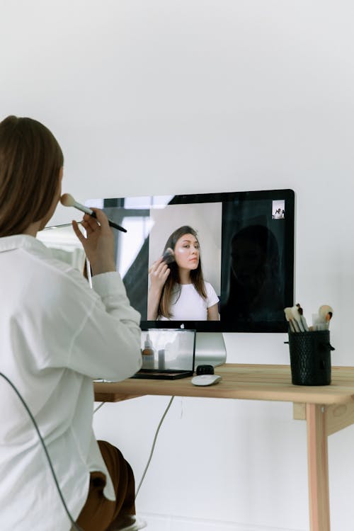 Free Photo Of Woman Applying Make-Up On Her Face Stock Photo