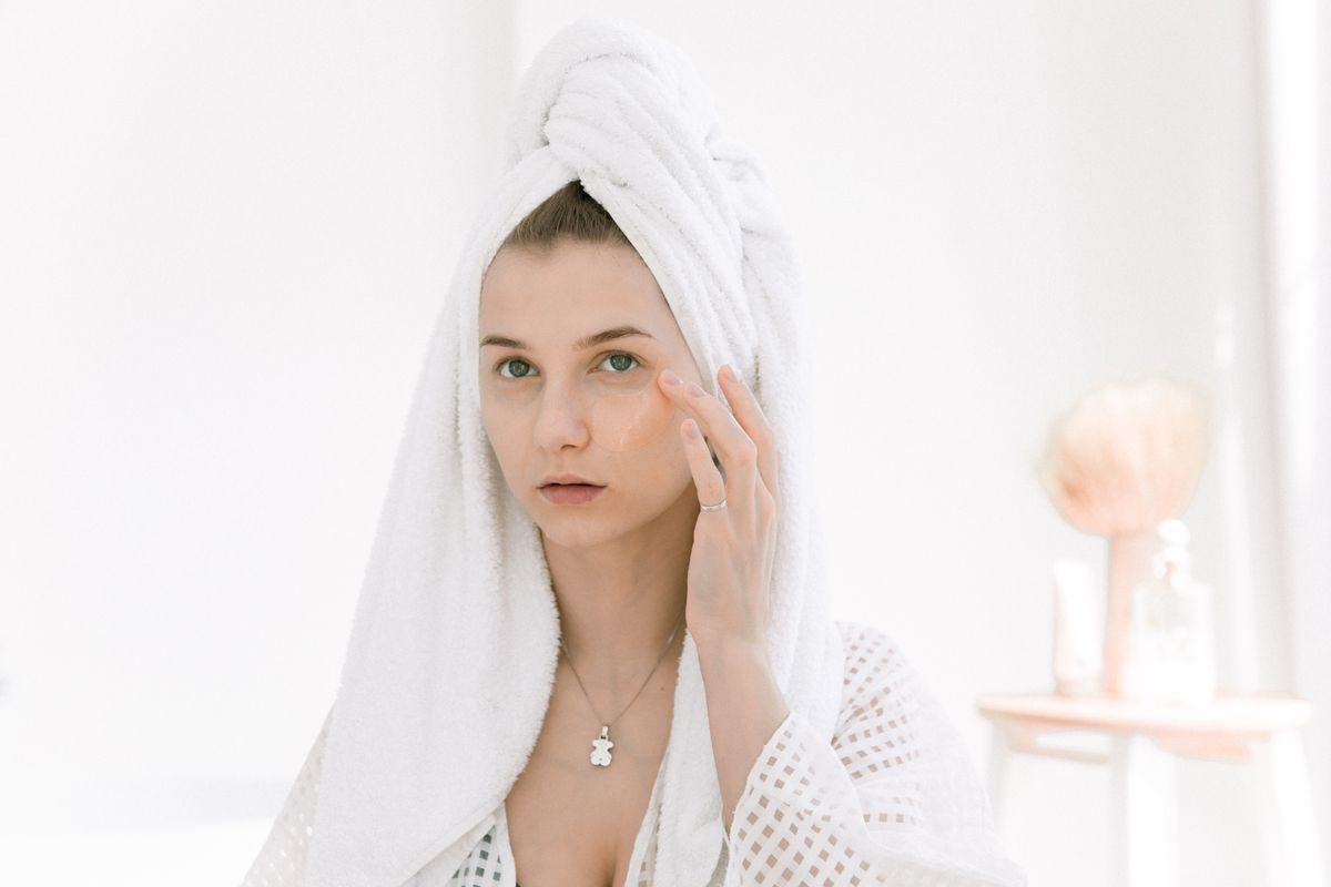 Woman touching her luminous skin during a bright skincare routine