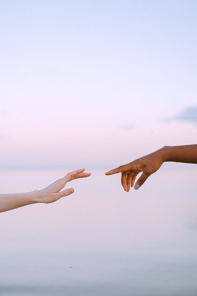 Photo Of People Reaching Each Other's Hands