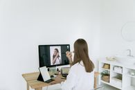 一名女子边视频通话边化妆，展现了现代美容程序与技术