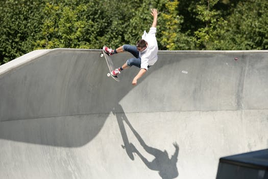 Action-packed photo of a skateboarder performing a high trick in an outdoor skatepark.