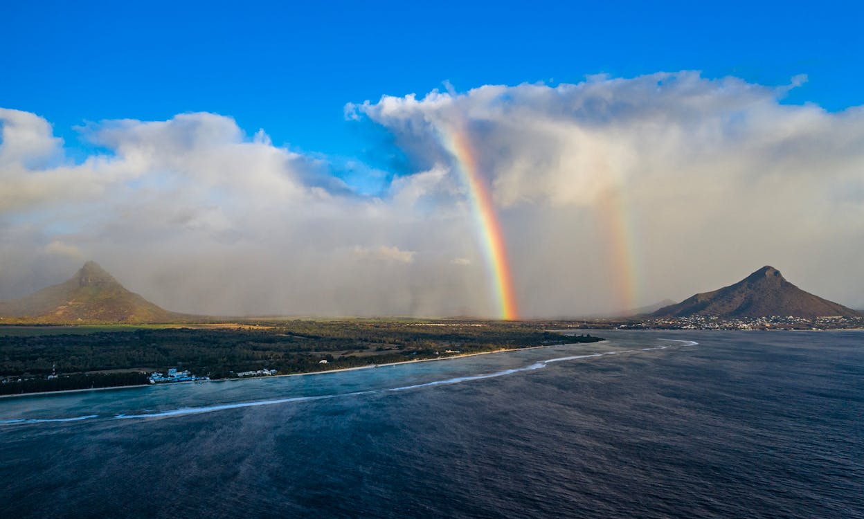Photo Of Rainbow Under Cloudy Sky