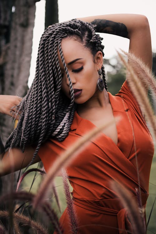 Free A Braided Woman in an Orange Top Stock Photo