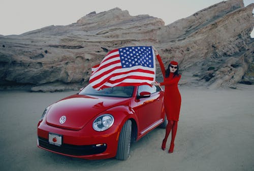 Photo Of Red Car Beside Woman 