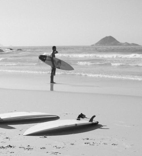 Photo Of Man Holding Surfboard
