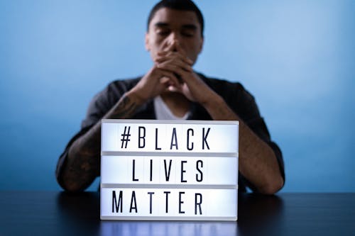 Free Man Behind a Black Lives Matter Sign Stock Photo