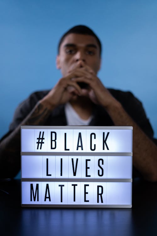 Man Behind a Black Lives Matter Sign