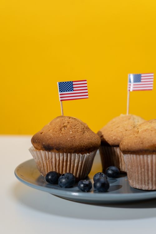 Free Delicious homemade blueberry muffins with American flags, perfect for patriotic celebrations. Stock Photo