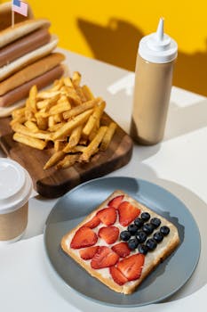 French fries and patriotic berry toast arranged on a table, showcasing a mix of fast and sweet foods.