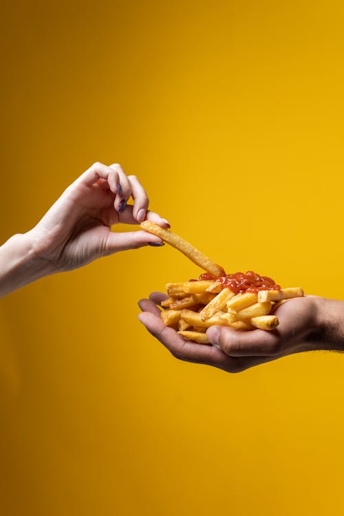 Person Sharing French Fries