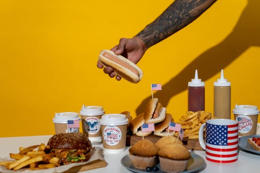 A vibrant display of American food celebrating Independence Day with hot dogs, burgers, and fries.