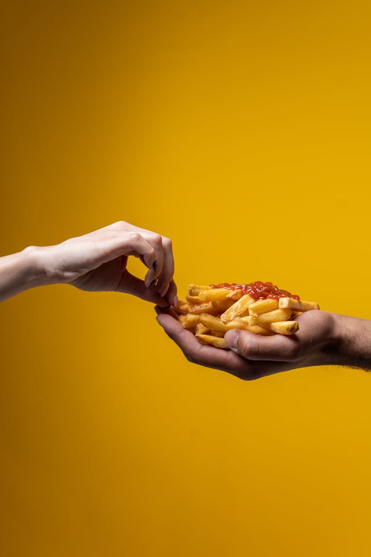 Person Sharing French Fries