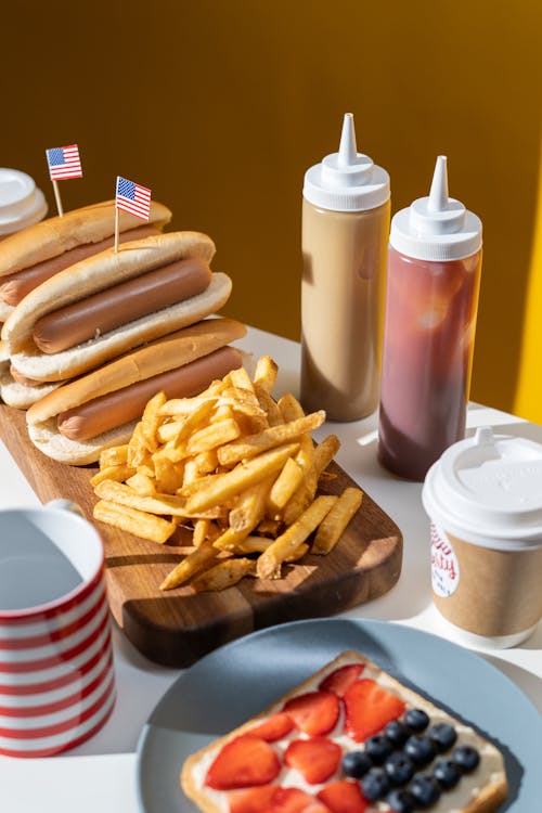  French Fries and Hotdogs Served on Table 