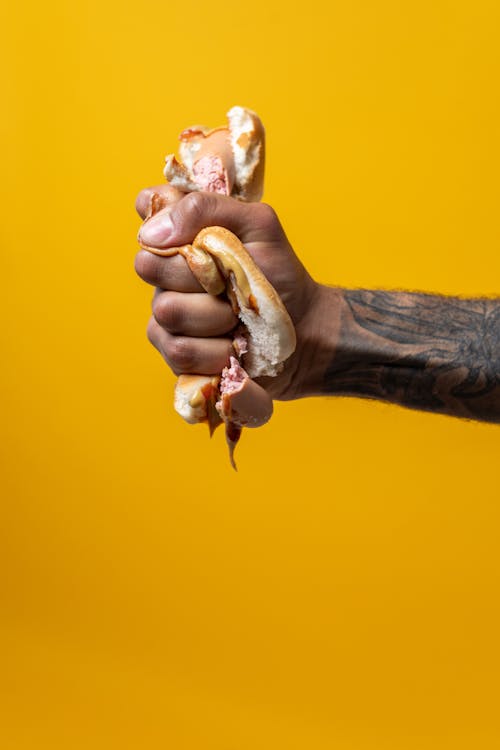 Free Person Squeezing Hotdog Stock Photo