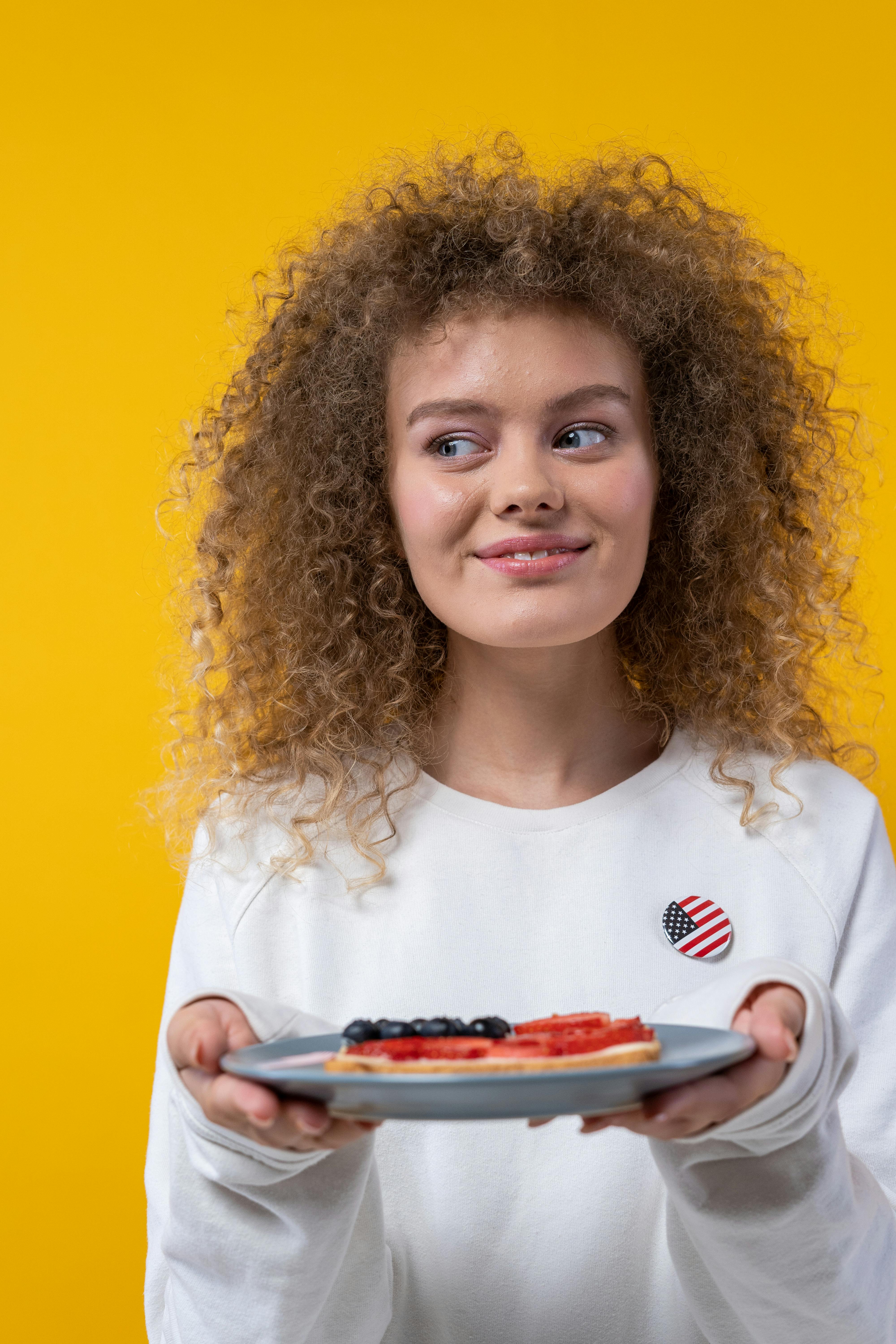 smiling woman holding a plate