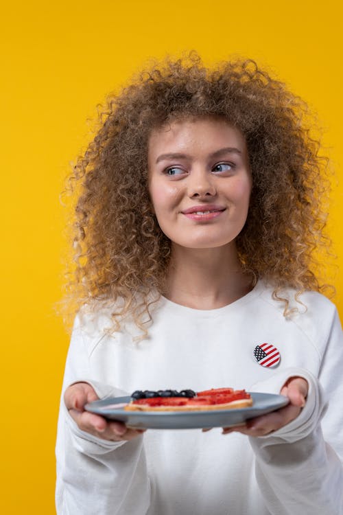 Smiling Woman Holding a Plate