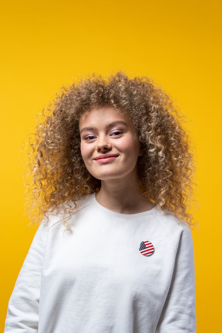 Smiling Woman Wearing An American Flag Pin