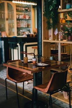 A stylish and modern bar with wooden seating, ready for guests. Perfect ambiance.
