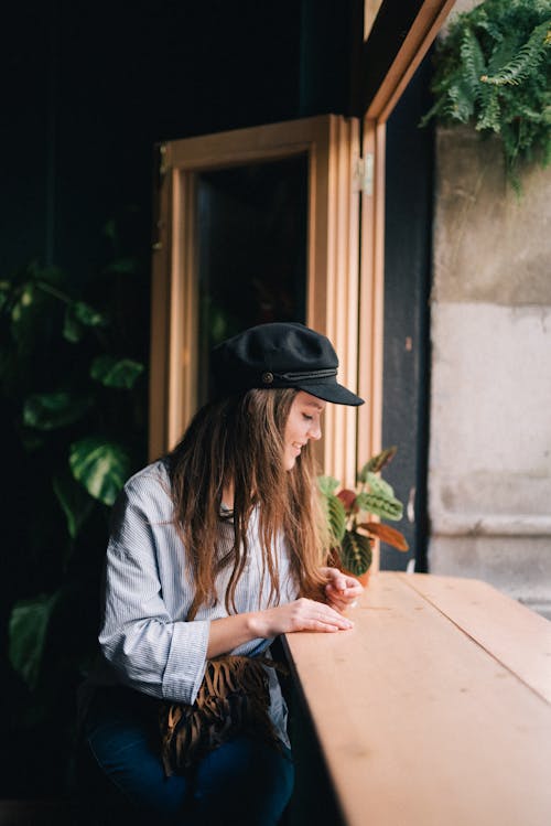 Free A Woman Sitting at the Table Stock Photo