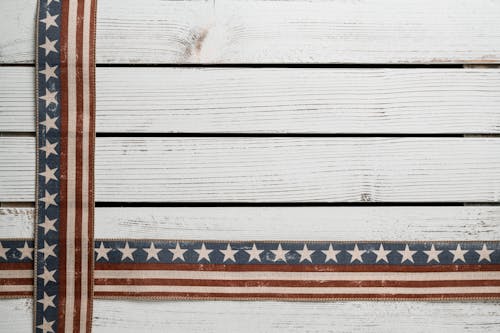 Crossed American flags on fence