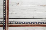Crossed American flags on fence