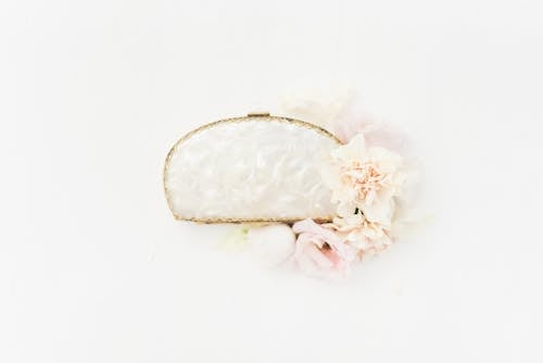 Elegant Accessory Displayed with Flowers against White Background
