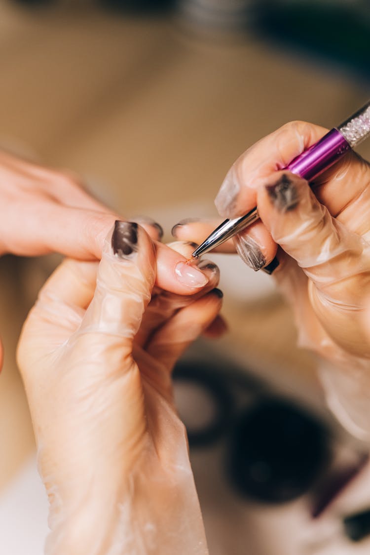 Nail Stylist Removing Cuticles