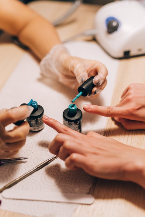 A Manicurist Holding Nail Brushes