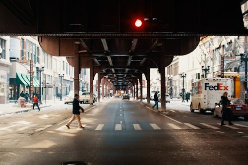 Unrecognizable people walking on crosswalk in city
