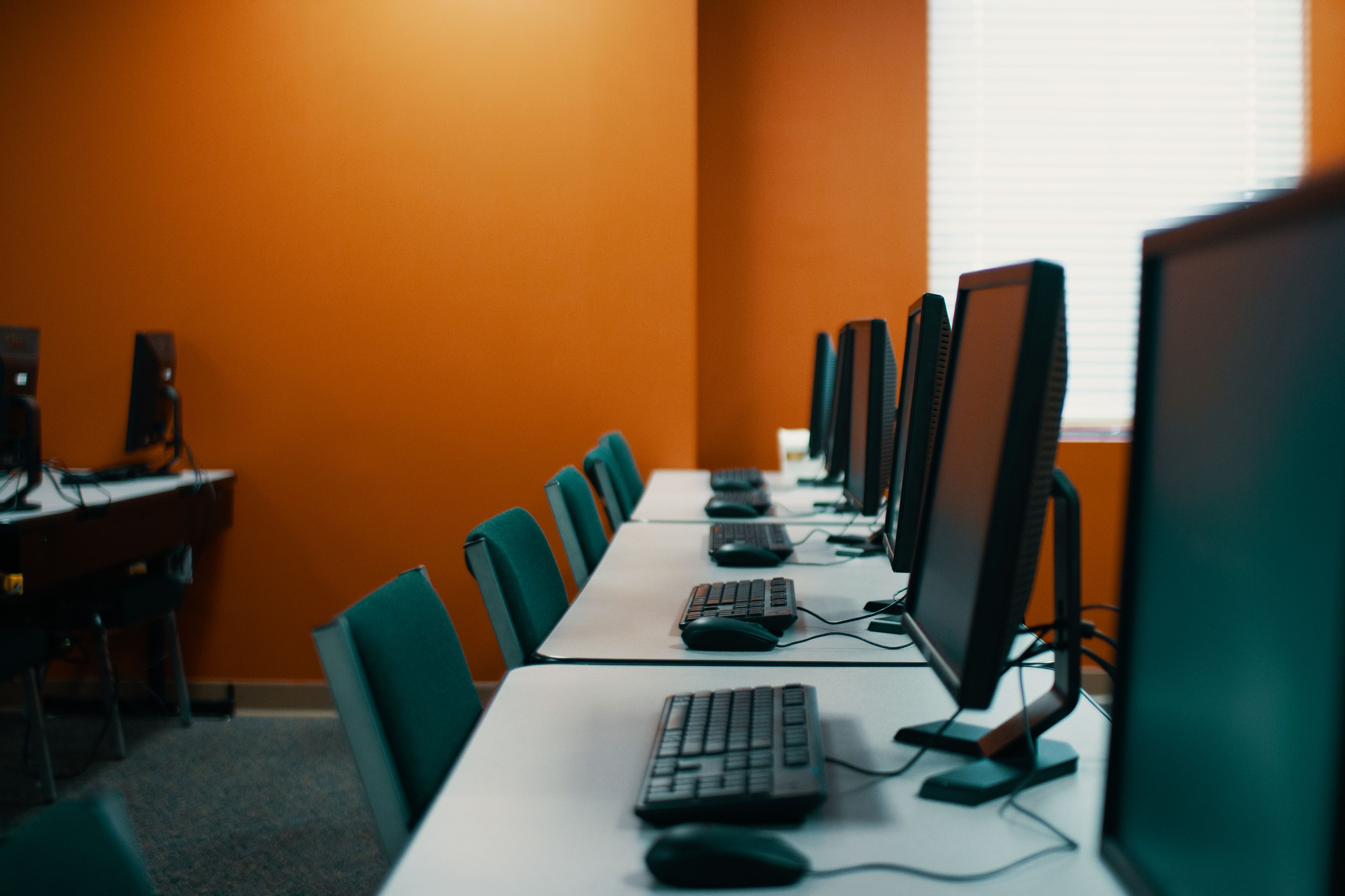 Modern computers and keyboards in office · Free Stock Photo